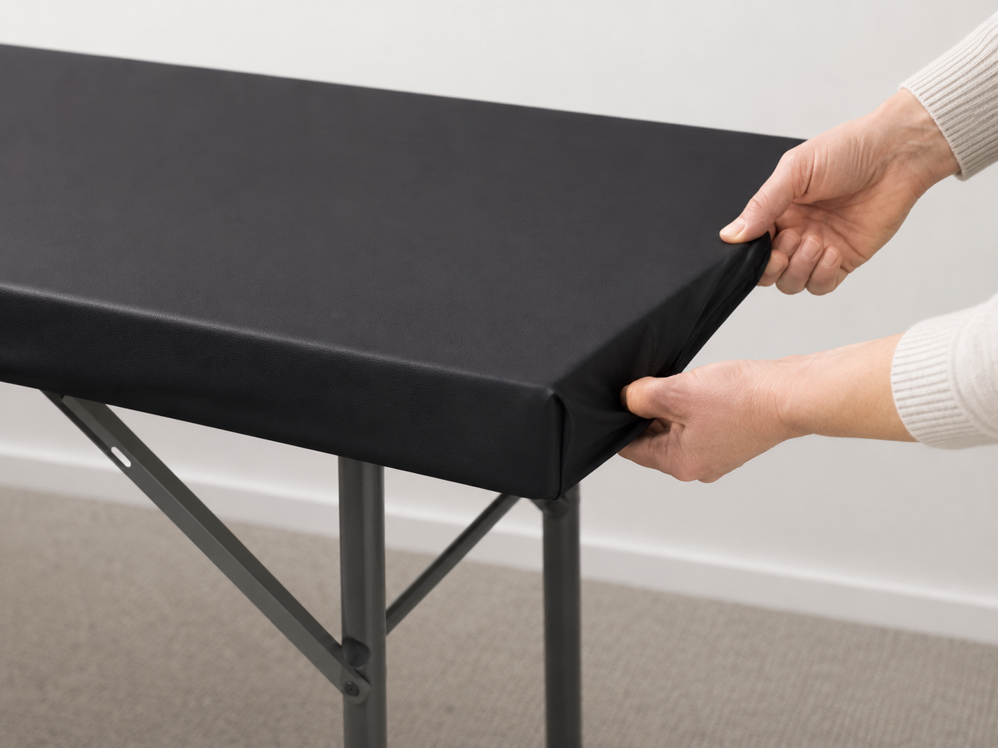 New black Q-Top being fitted onto a folding table